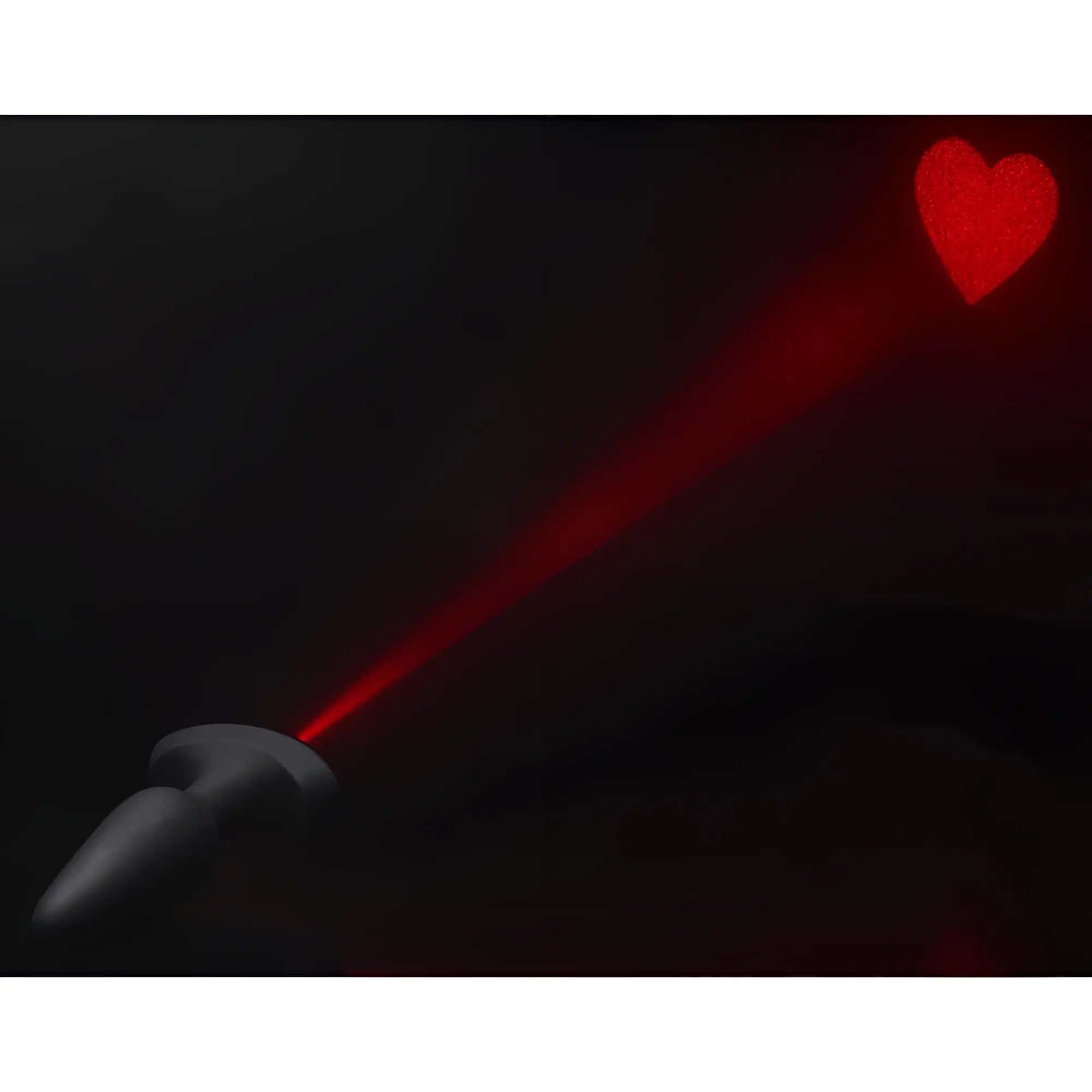 Booty Sparks 28X black silicone anal plug projecting a red laser heart onto a dark background.