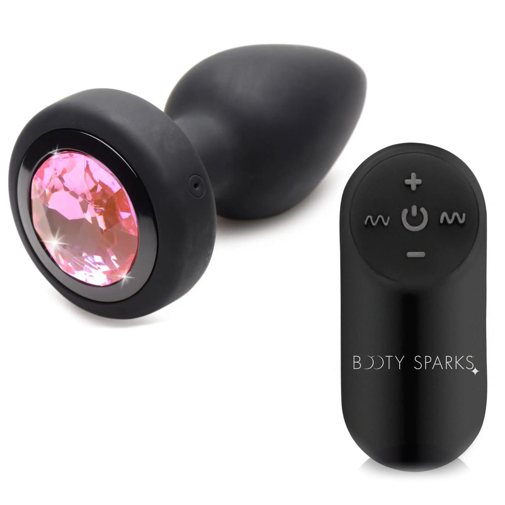 Booty Sparks 28X vibrating black silicone anal plug with a pink crystal gem and a matching remote control.