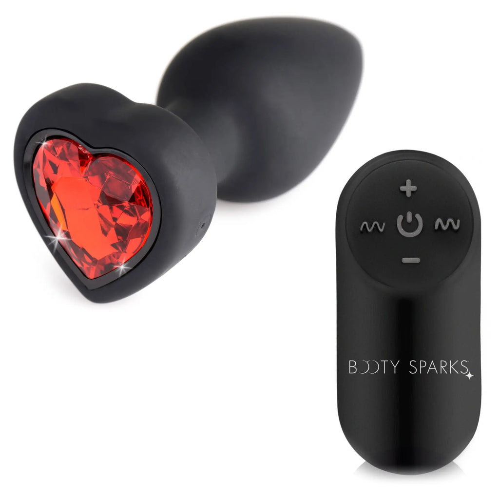Booty Sparks 28X vibrating black silicone anal plug with a sparkling red heart-shaped base and a wireless remote.