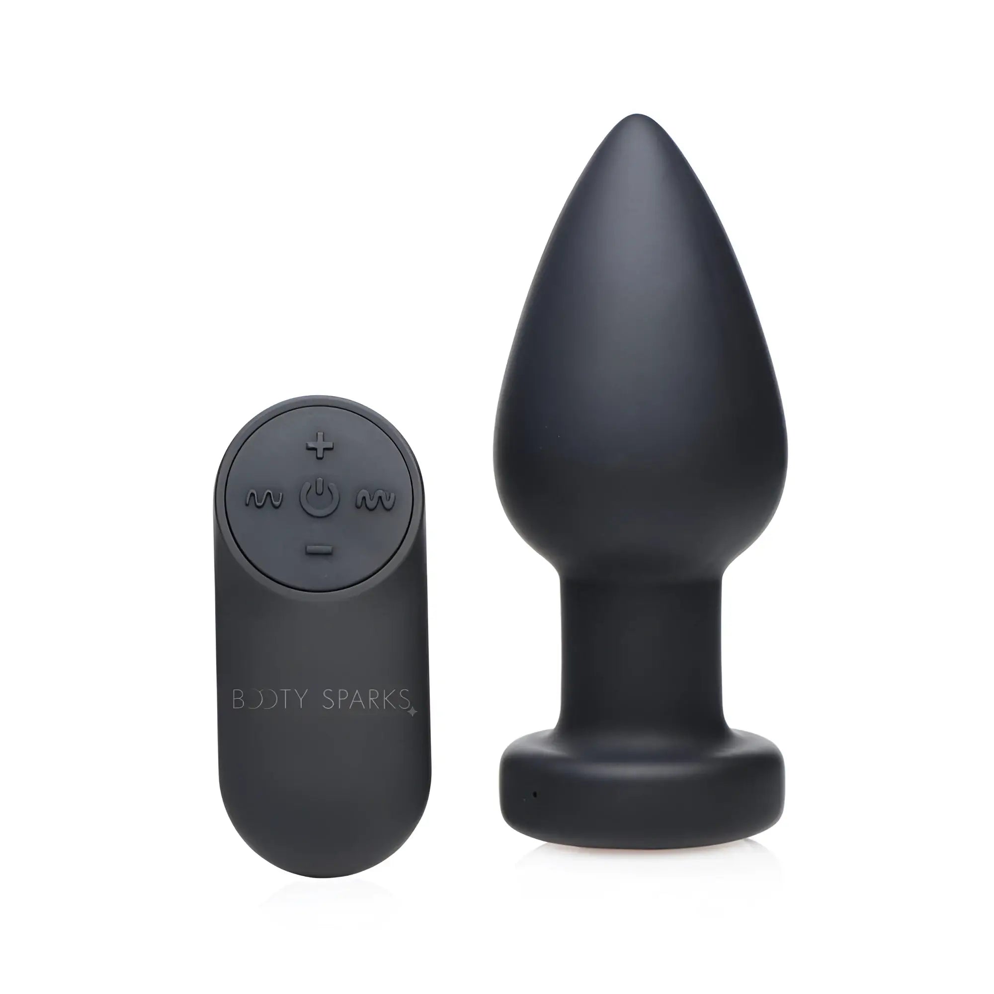 Booty Sparks 7X matte black anal plug next to a matching remote control with power and function buttons.