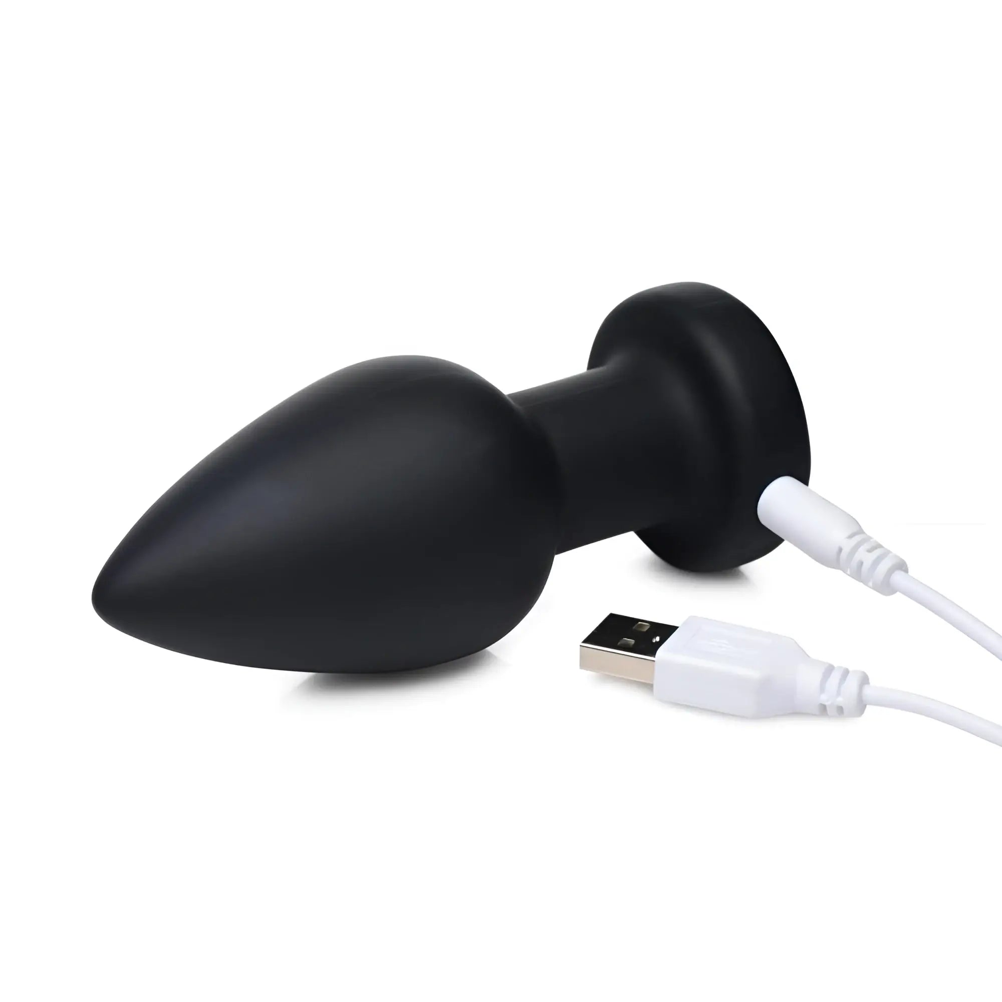 Booty Sparks 7X: Black, matte, teardrop-shaped rechargeable anal plug shown with its white USB charging cable.