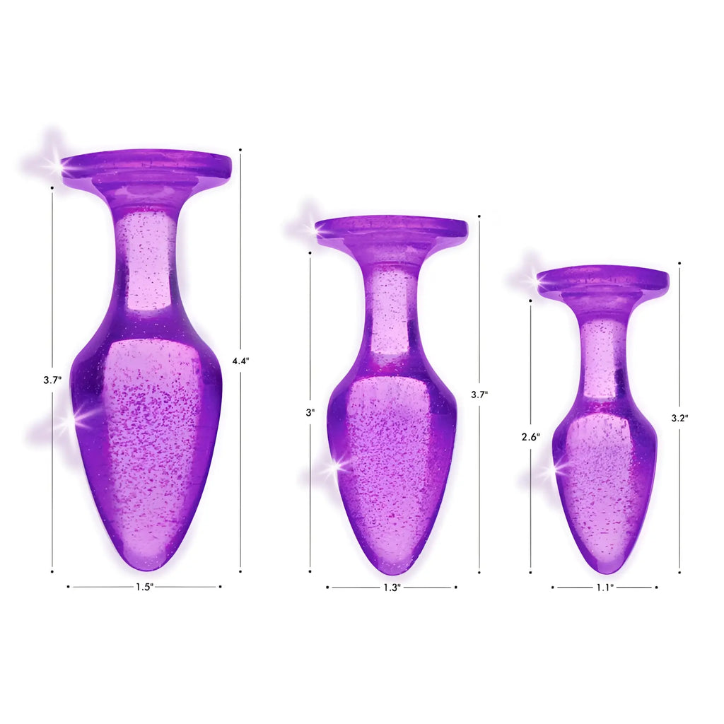 Booty Sparks Glitter Gem Anal Plug set: three purple, translucent, glitter-infused plugs shown with size dimensions.