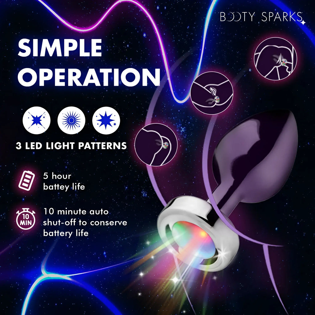 Booty Sparks light-up anal plug: a purple, tapered silicone plug with a glowing, multi-colored LED metal base.