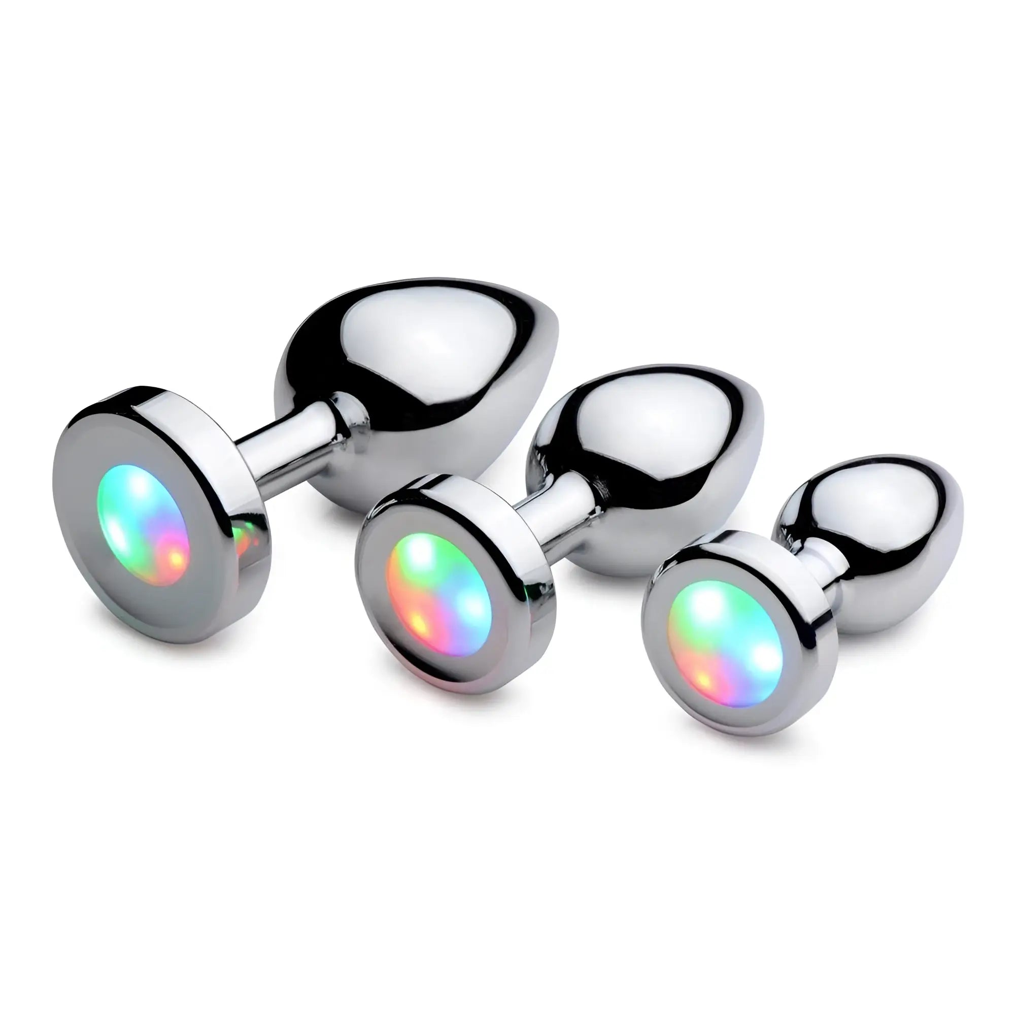 Three chrome-finished Booty Sparks anal plugs with glowing, multi-colored LED bases on a white background.