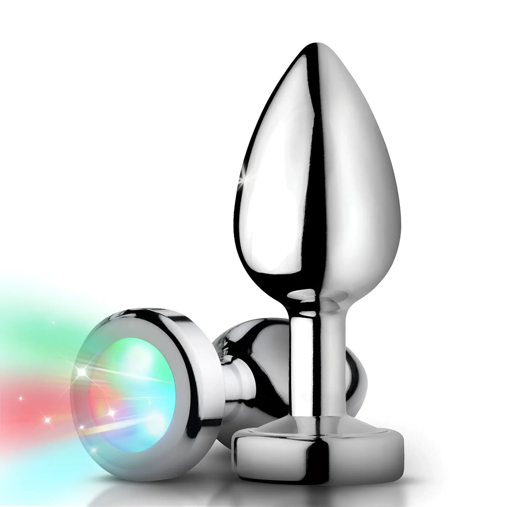 Booty Sparks Light Up Anal Plug: two chrome, teardrop-shaped metal plugs, one glowing with red and teal LED light.