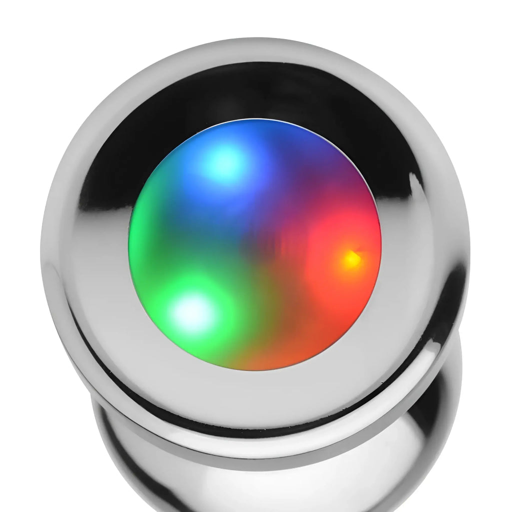 Booty Sparks Light Up Anal Plug: A shiny, metallic silver plug featuring a glowing red, green, and blue LED light core.