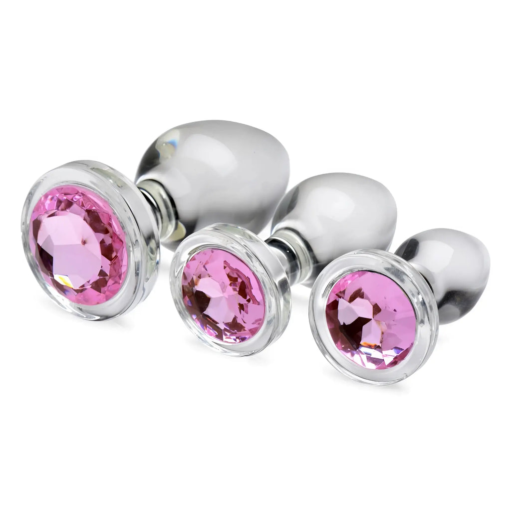 Booty Sparks glass anal plug set in three sizes, featuring clear glass bodies and sparkling pink gemstone bases.
