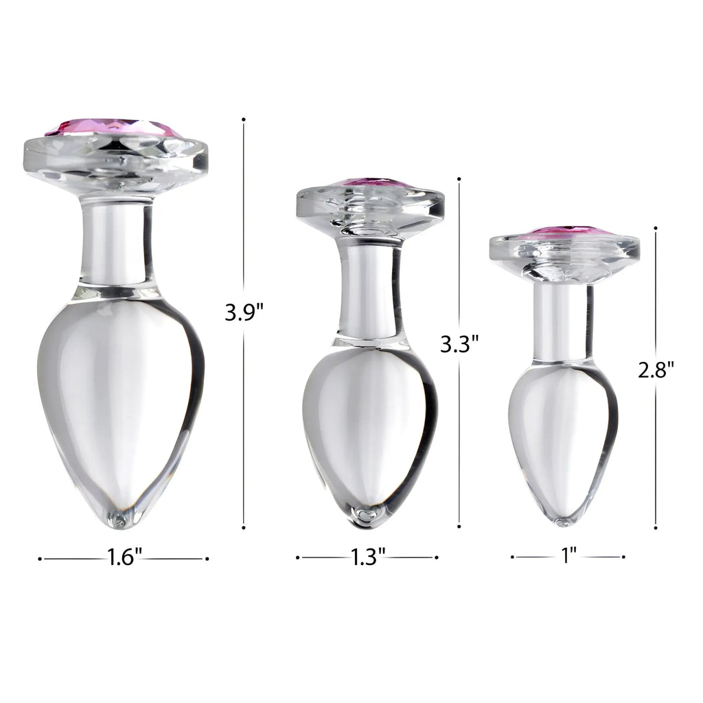 Booty Sparks Pink Gem Glass Anal Plugs: three clear glass plugs with pink gems, shown in sizes 2.8, 3.3, and 3.9 inches.