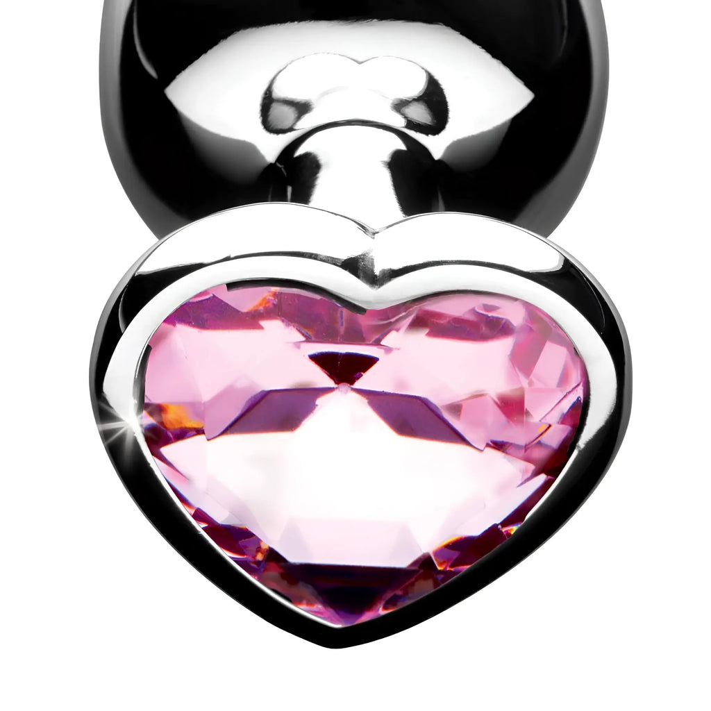 Booty Sparks Pink Heart Anal Plug featuring a metallic base and a faceted, sparkling pink heart-shaped crystal jewel.