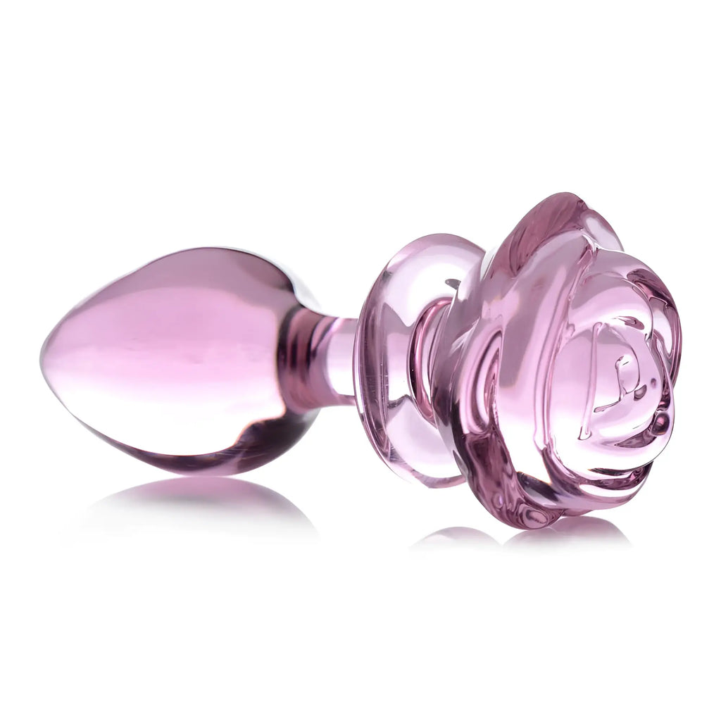 Booty Sparks pink rose glass anal plug with a smooth, tapered tip and a sculpted floral base in translucent pink.