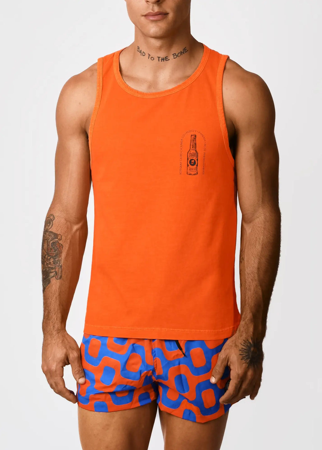 Bright orange sleeveless cotton tank top with small printed bottle graphic on left chest by BOTEQUIM CA-RIO-CA men’s wear
