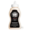 9oz squeeze bottle of Boy Butter Extreme desensitizing lubricant with a black label on a tan, cream-colored bottle.