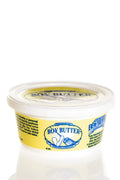 Yellow-labeled plastic container of boy butter original formula personal lubricant with clear lid and blue branding