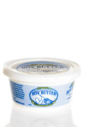 A white plastic container of boy butter water based gel featuring blue and yellow branding on the front