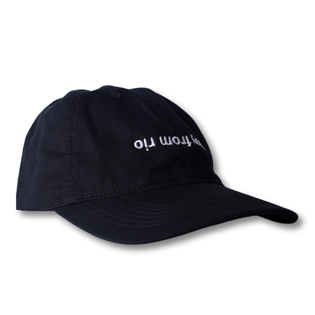 Black dad hat with white embroidered hop from rio text in a boy from rio flip design