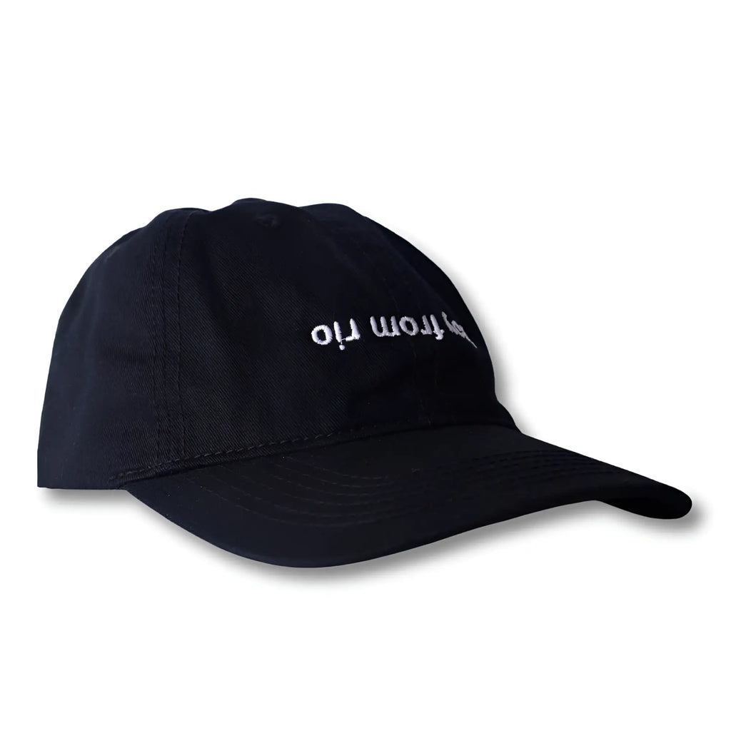 Black dad hat with white embroidered hop from rio text in a boy from rio flip design