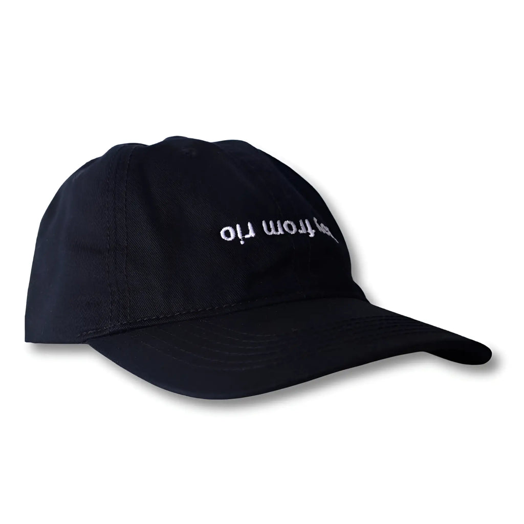 Black dad hat with white embroidered from rio text across front in boy from rio flip design