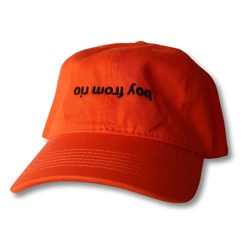 Bright orange dad hat with black embroidered text boy from ori on front in boy from rio flip style