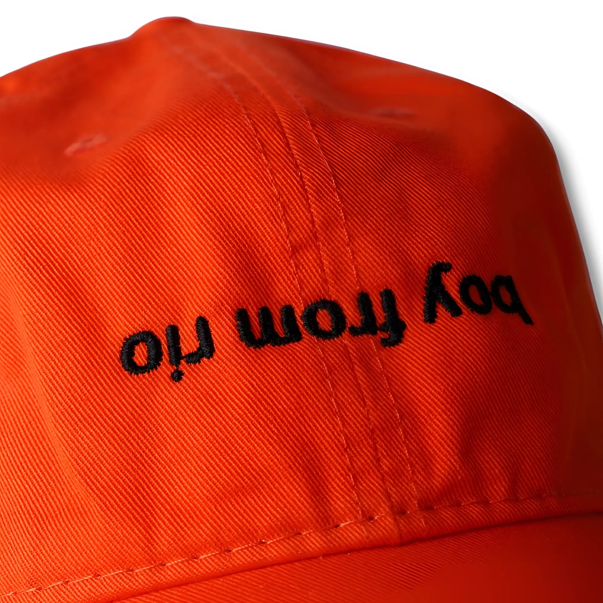 Bright orange dad hat with black embroidered boy from iri text perfect for casual outdoor wear