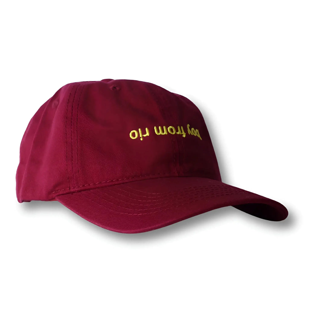 Maroon dad hat with gold embroidered boy from rio text on the front ideal for casual wear