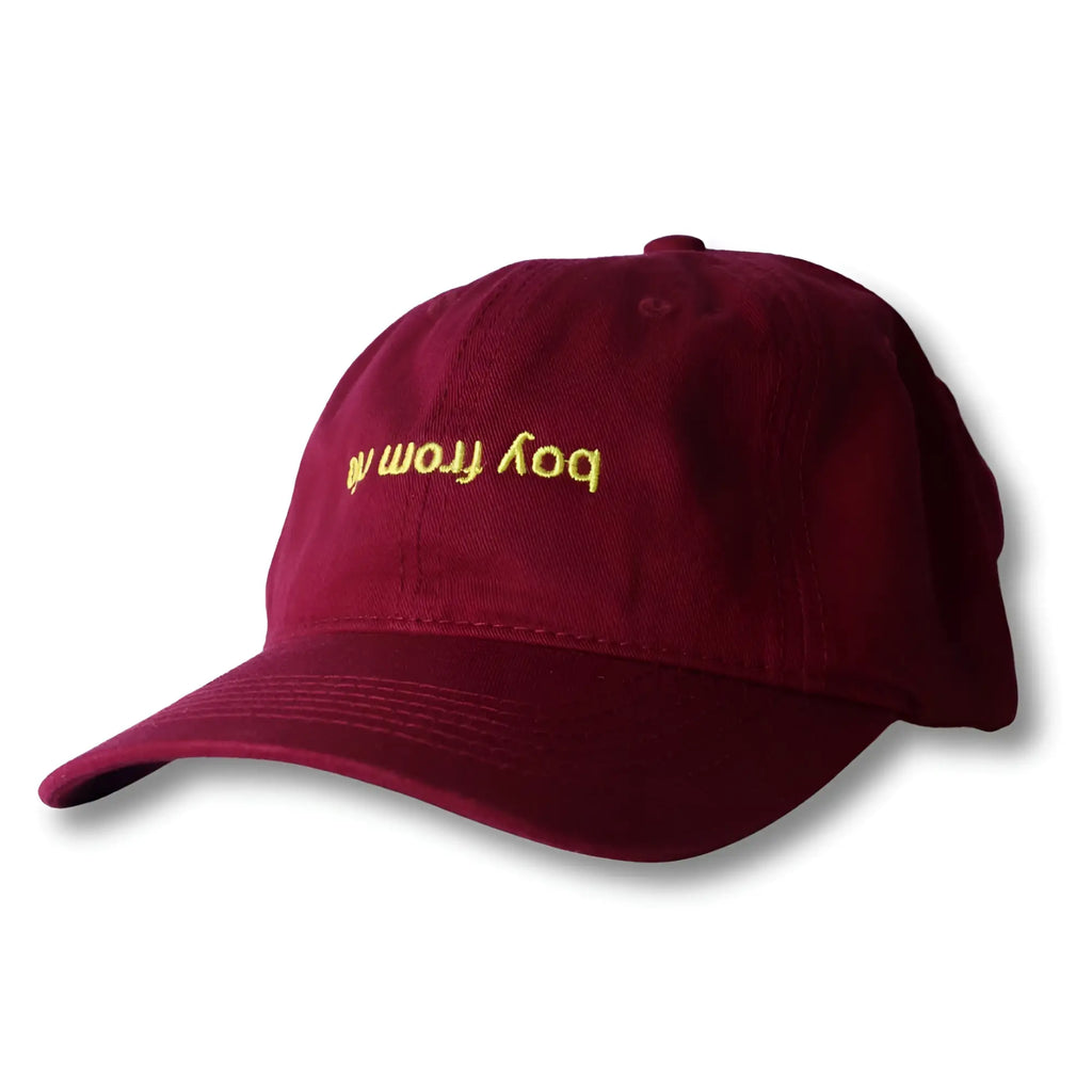 Maroon dad hat with gold embroidered boy from text on front from boy from rio flip collection