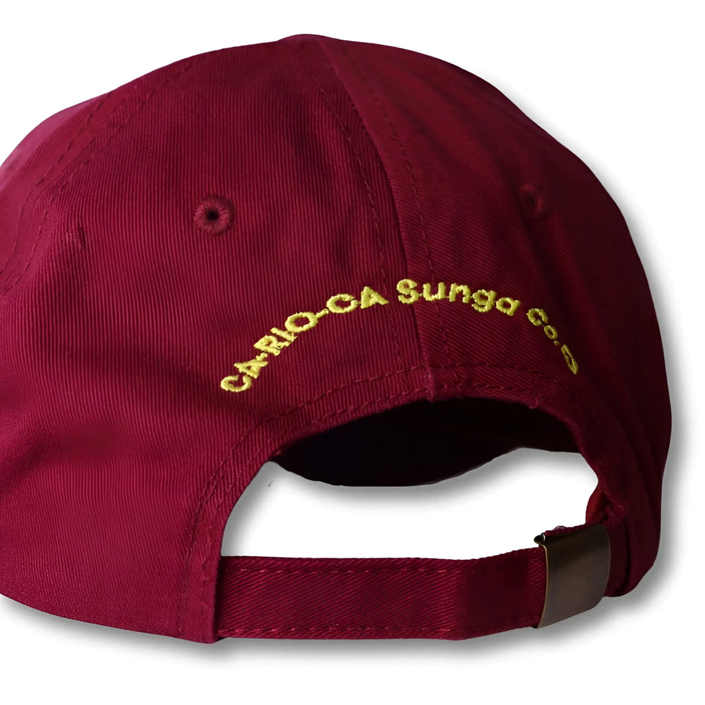 Back side of maroon cotton dad hat with gold embroidered cario-ca sunga co text from boy from rio flip collection