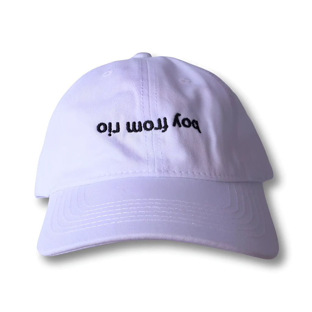 White dad hat with black embroidered boy from rio text made of soft cotton for casual outdoor wear