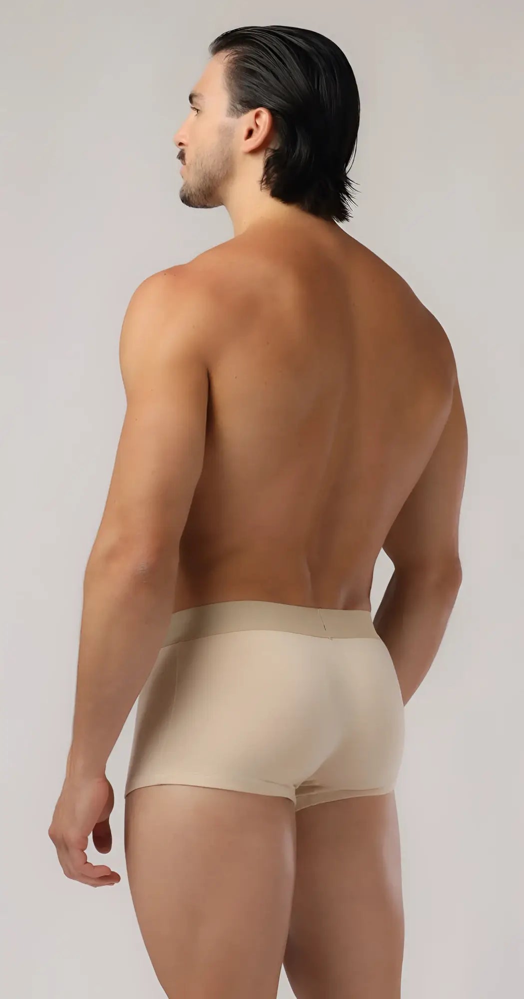 Beige boyshorts made of smooth form-fitting fabric with a subtle elastic waistband for comfortable wear