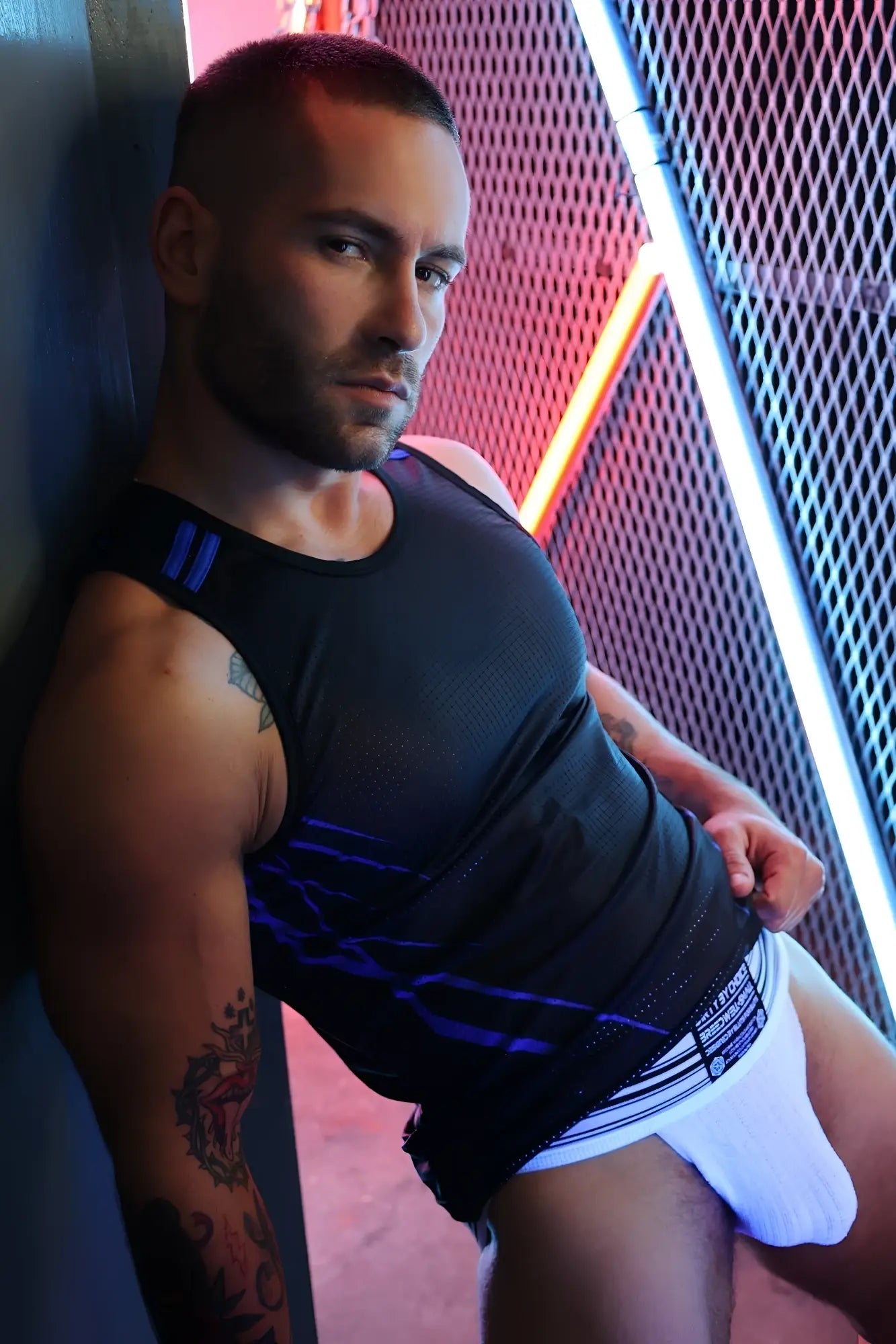 Black Revolution tank top with blue graphic design and three vertical stripes on shoulder strap in lightweight fabric