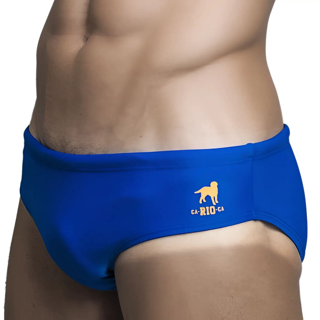 Brief cut solids sunga male bathing suit in blue with yellow dog logo and ca-rio-ca text on the side
