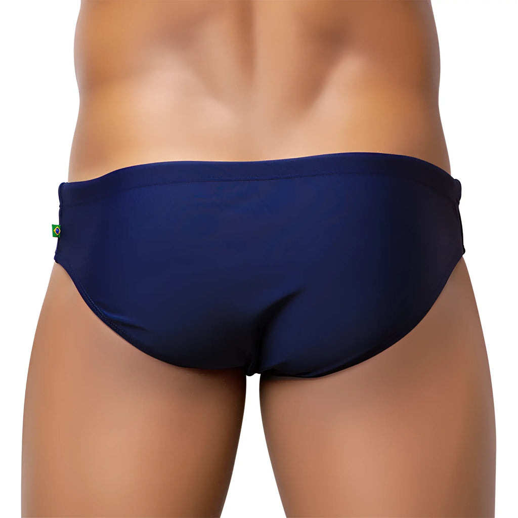 Navy blue brief cut solids sunga male bathing suit with a small green and yellow flag tag on the side seam