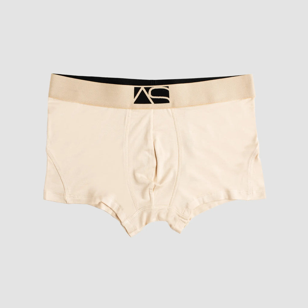 Beige brief trunks boxer briefs with black waistband featuring stylized as logo for comfortable everyday wear