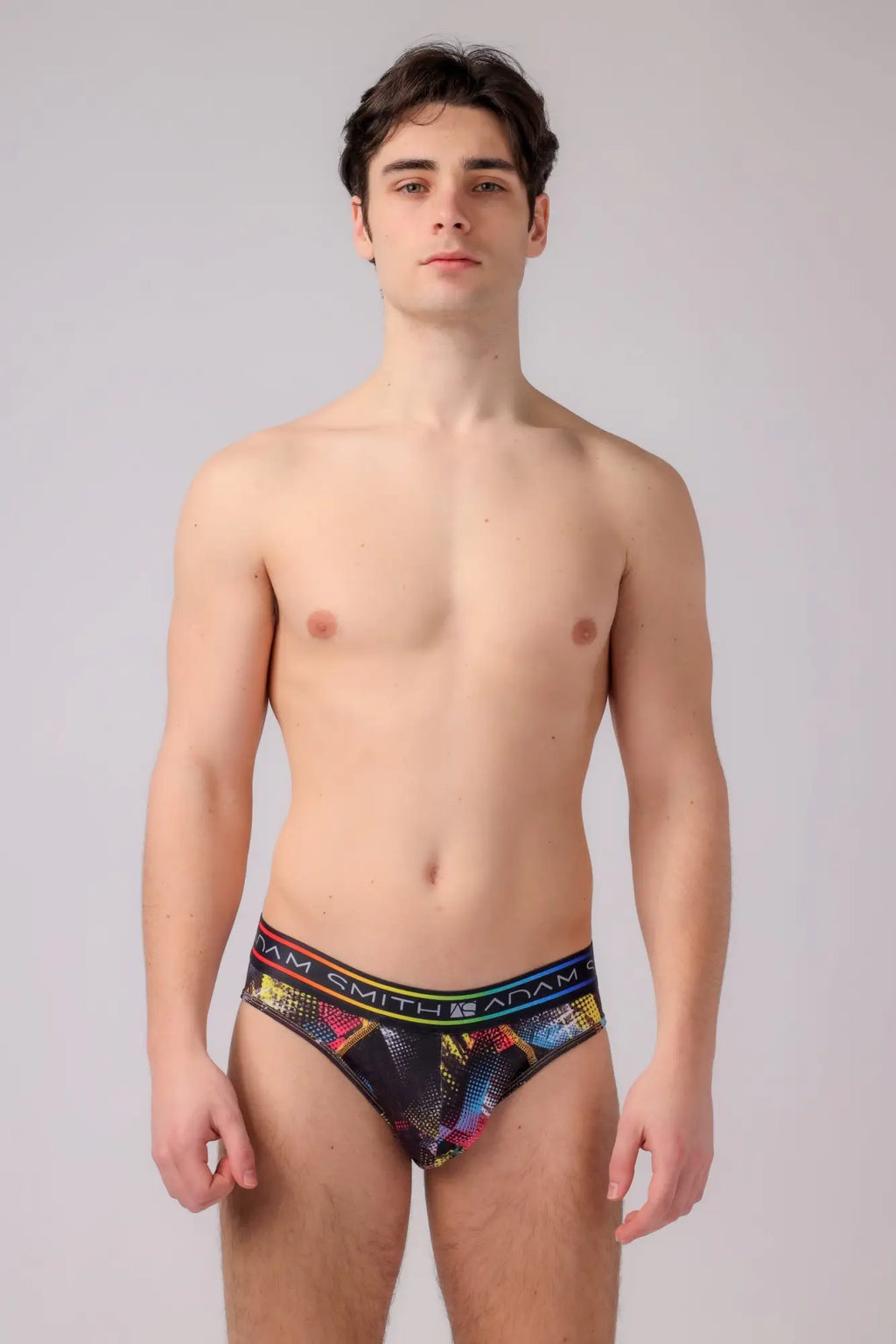 Adam Smith briefs featuring a black base with vibrant multicolored geometric patterns and colorful waistband accents