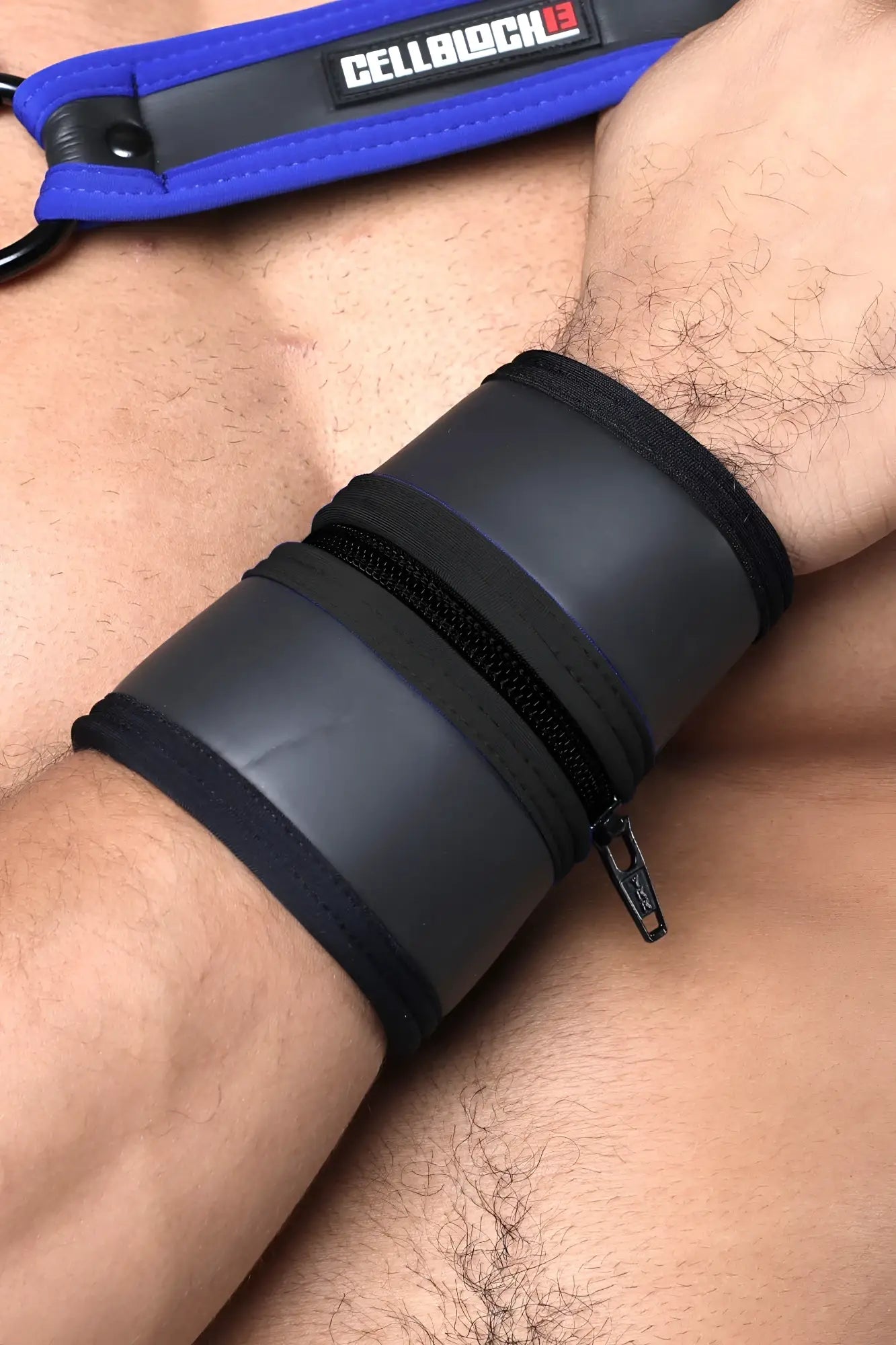 Black leather buckle up cuff with zipper closure and blue branded strap available in 5 colors