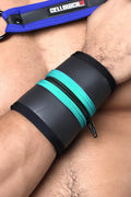 Black and teal zippered wrist cuff with blue strap featuring cellblock logo from buckle up cuff collection