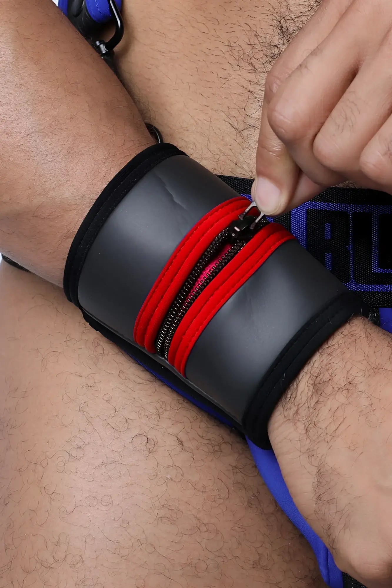 Black buckle up cuff wristband with red zipper accents in durable fabric available in five colors