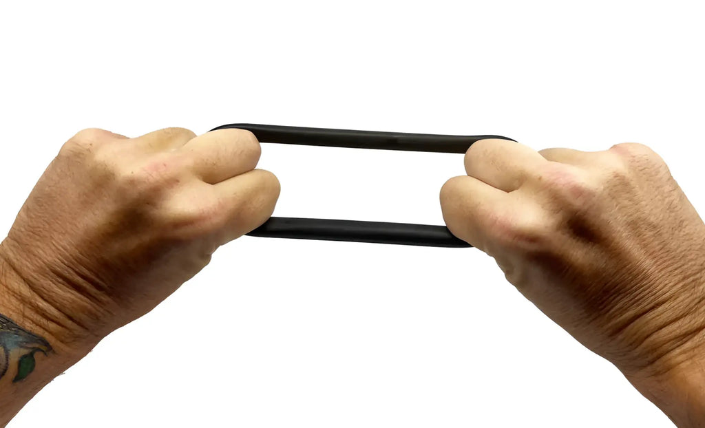 Black rubber BUFU RING being stretched between two hands showing its flexible and durable material quality
