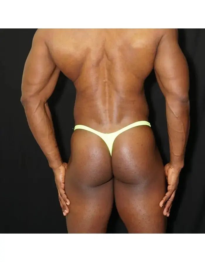 Men's green fluor thong underwear by Arroyman featuring a minimal design and elastic waistband shown on a model from the back.
