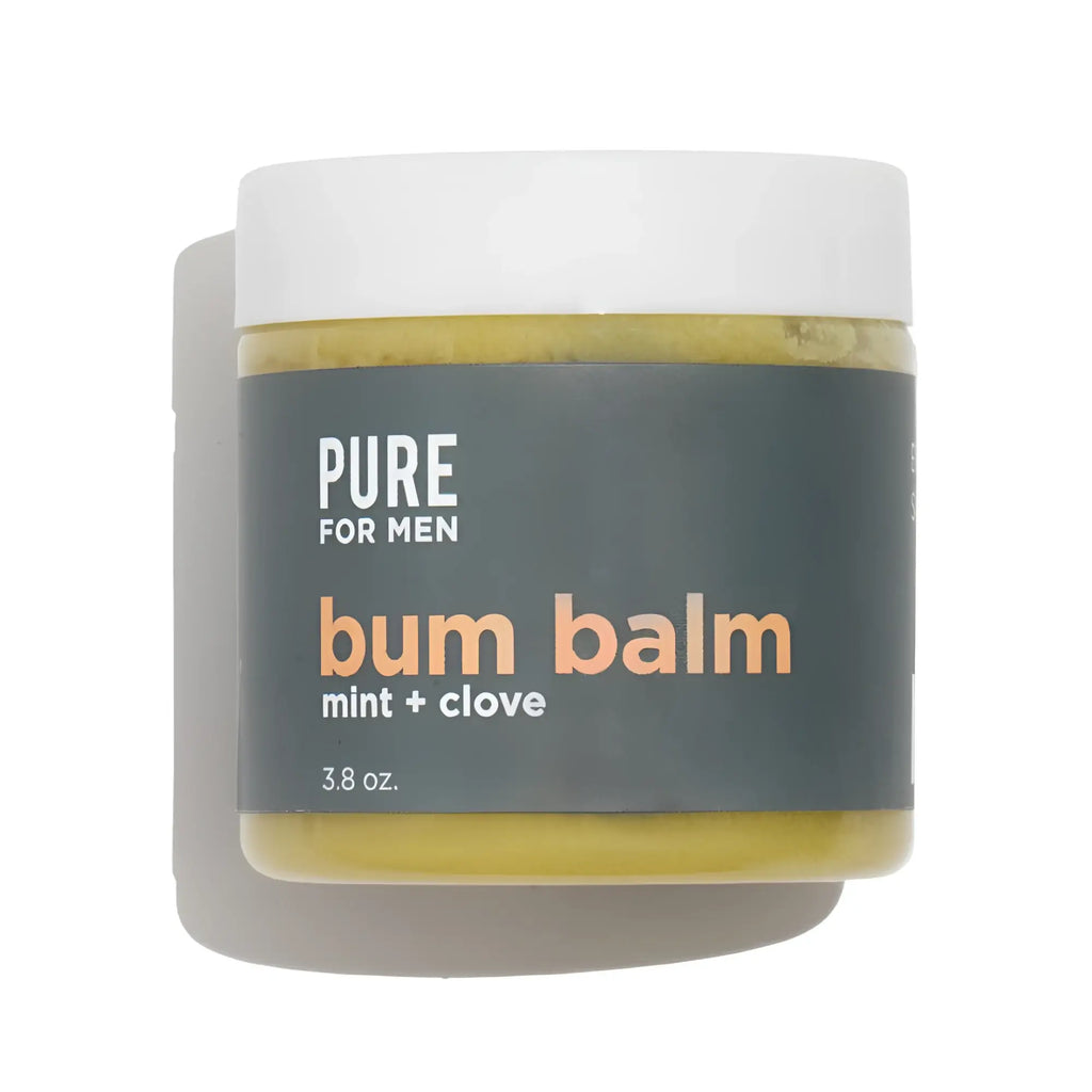 A matte white jar of pure for men bum balm with a dark gray label and yellowish green mint and clove balm