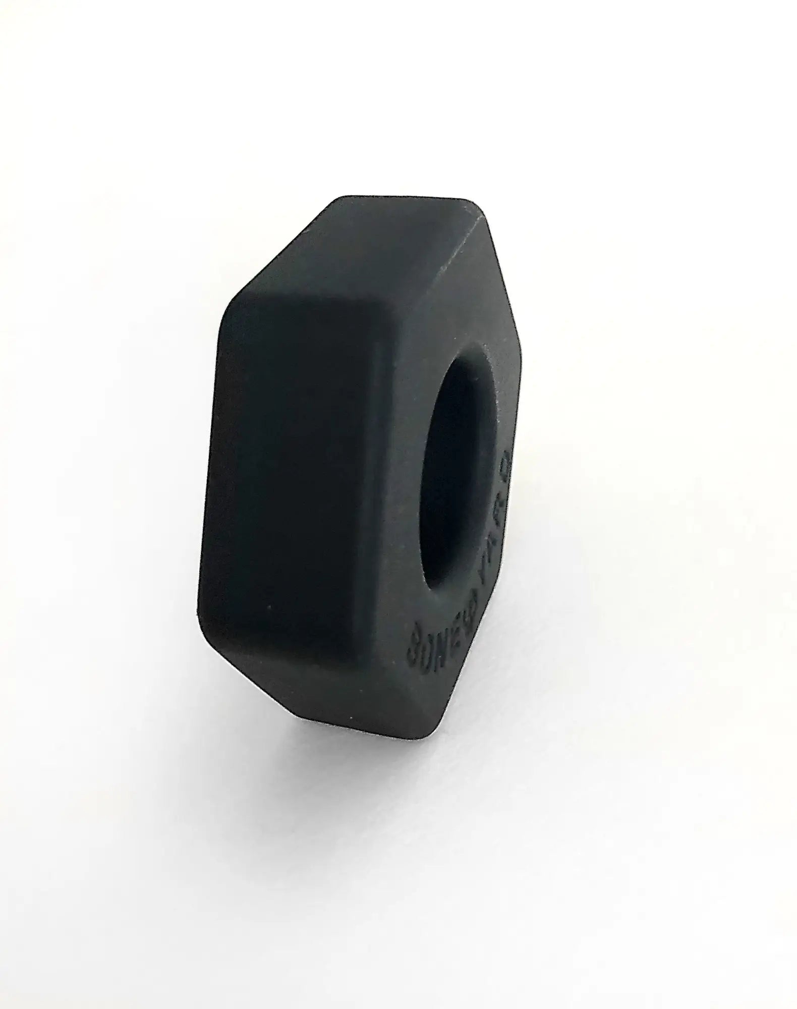 Black hexagonal nut with a matte finish and engraved text on the side for bust a nut product