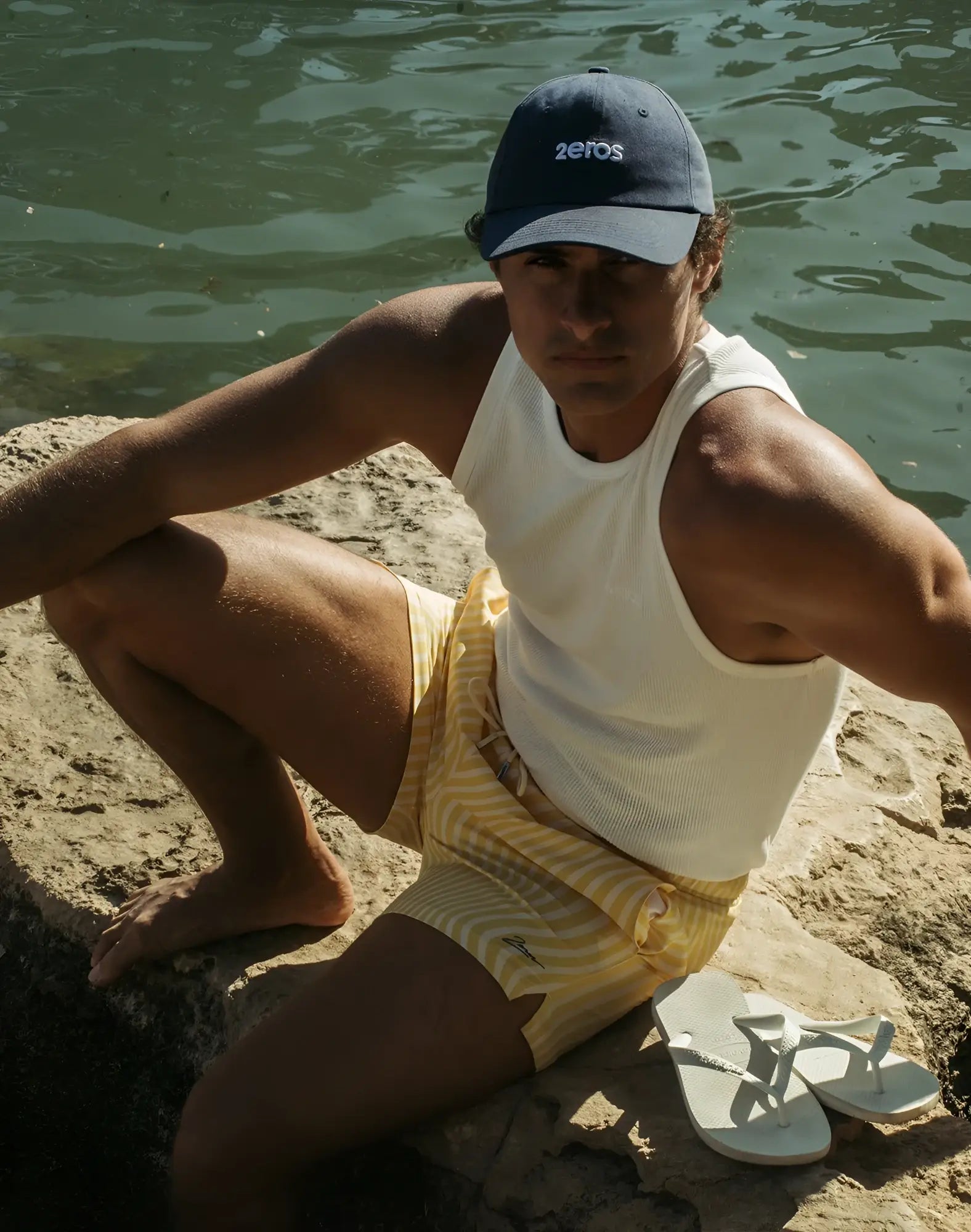 Navy blue baseball cap with white embroidered 2eros logo paired with byron swim short in dolce yellow