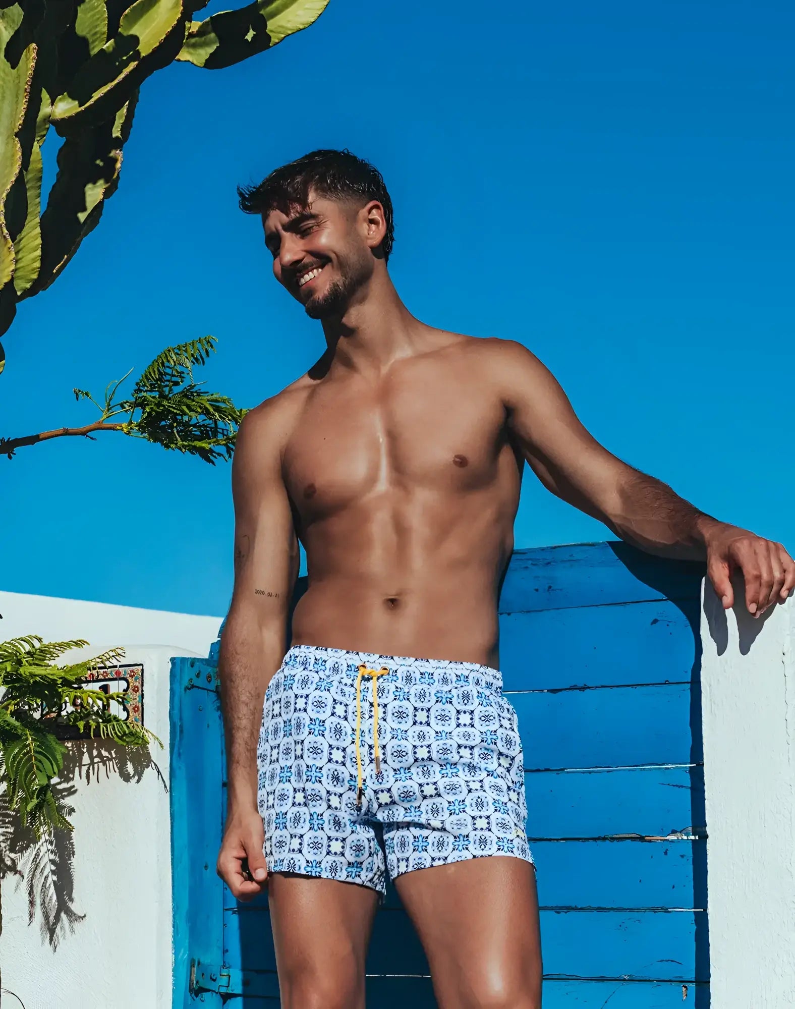 Byron swim short in white with blue geometric Mykonos print and yellow drawstring for casual beachwear
