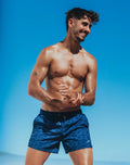Byron swim short signature print with blue patterned swim trunks featuring subtle wave design and black waistband