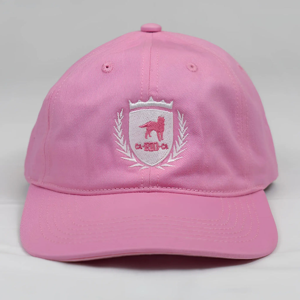 Pink cotton ca-rio-ca crest logo embroidered baseball cap with white shield emblem featuring pink dog and laurel wreath