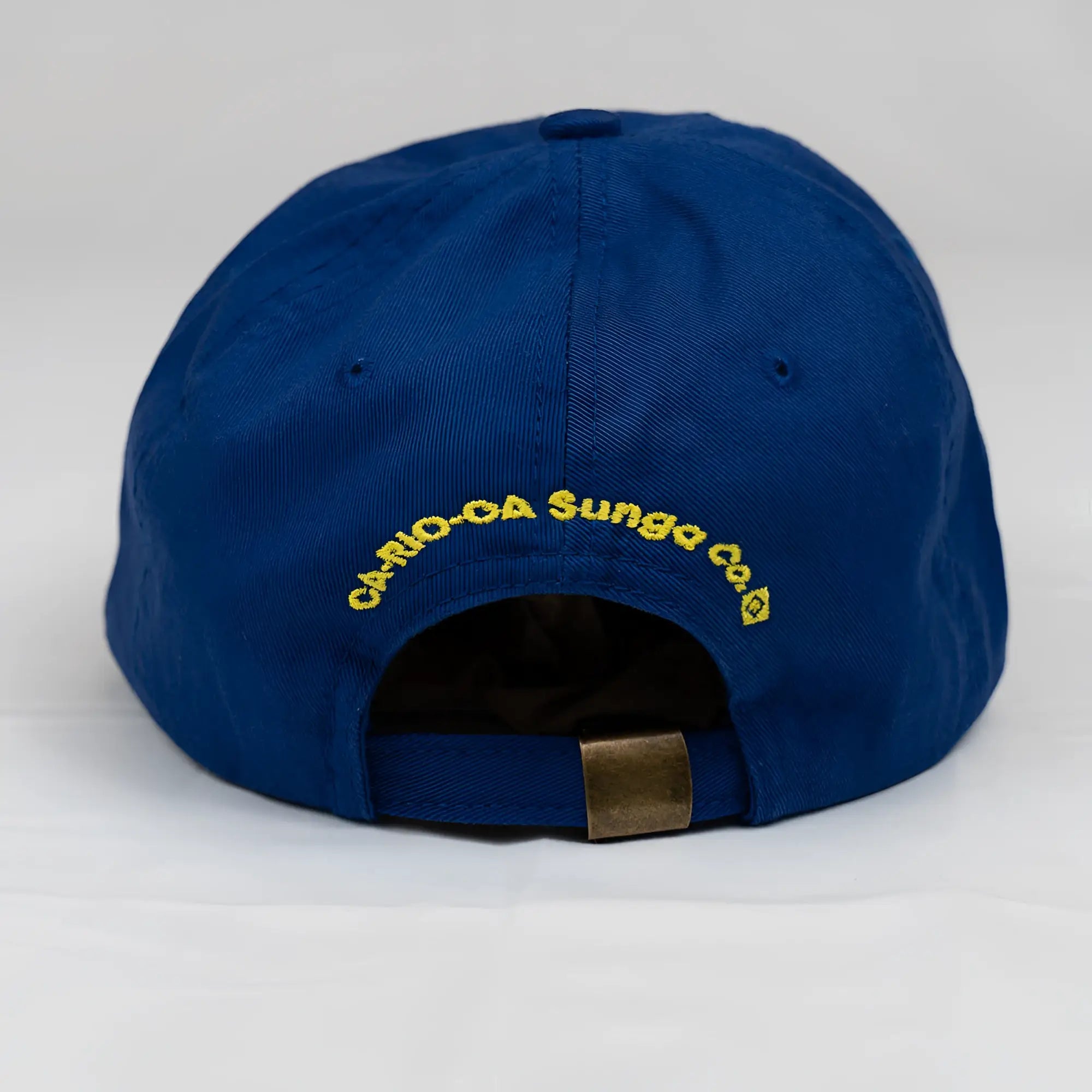 Royal blue cotton baseball cap with yellow cario-da sungco co logo and brass metal adjustment strap