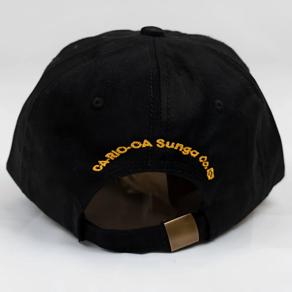 Black ca-rio-ca designer dad hat with gold embroidered crest logo and brass metal adjustment strap on the back