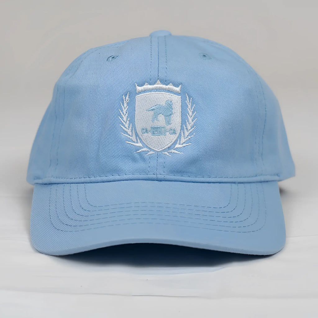 Light blue cotton dad hat featuring white embroidered CA-RIO-CA crest logo with lion and laurel wreath design