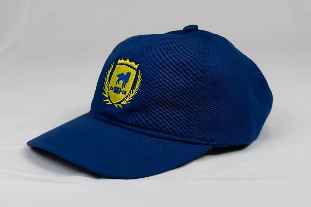 Navy blue CA-RIO-CA designer dad hat featuring yellow embroidered shield emblem with horse silhouette and laurel wreath