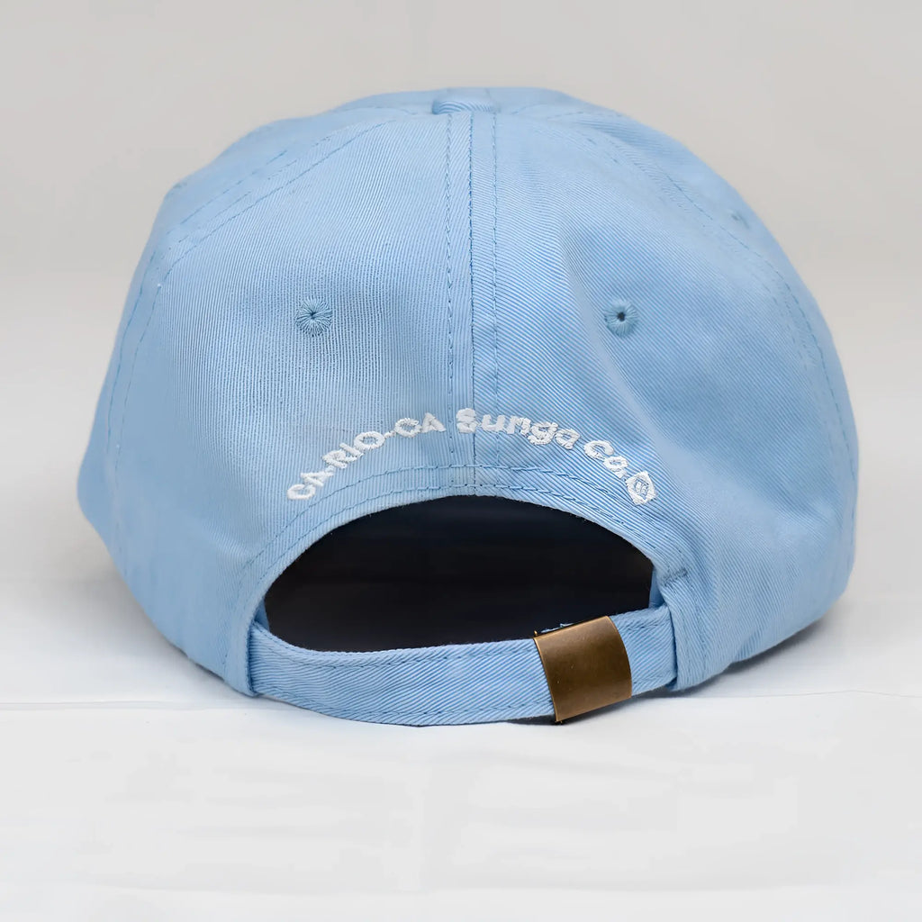 White CA-RIO-CA dad hat with red embroidered crest featuring a white dog silhouette and laurel leaves detailing