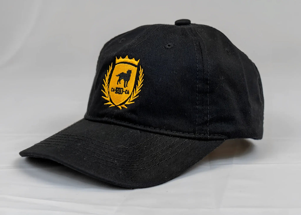 Black cotton ca-rio-ca crest logo embroidered dad hat with gold shield emblem featuring dog silhouette and laurel wreath